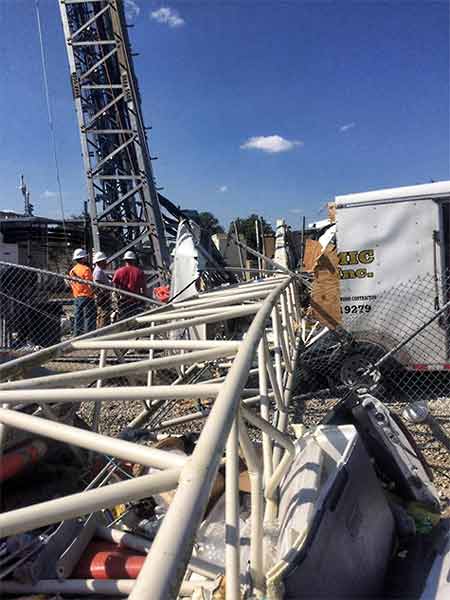 Crew members of Dynamic South were uninjured when a crane came inches away from knocking down a 350-foot tower when it collapsed.