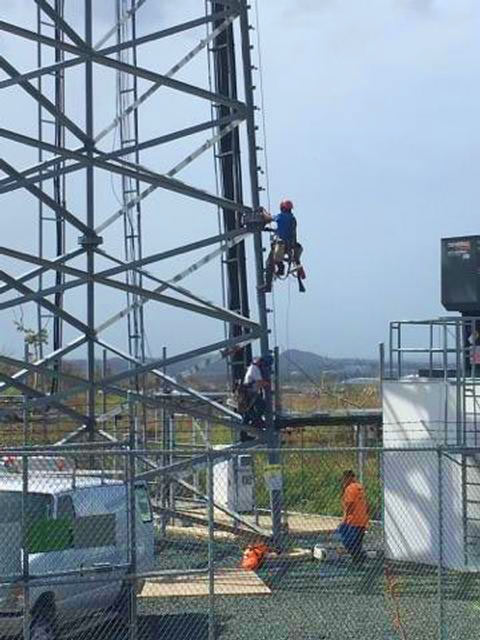 Tower techs work on a T-Mobile Puerto Rico cell site. The carrier said it has restored service to nearly 240 sites.