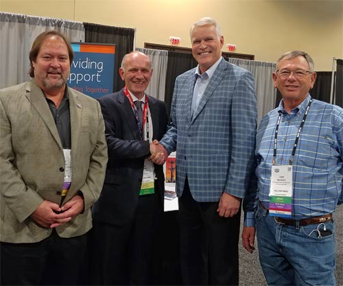 Duane MacEntee, third from left, is congratulated by Tower Family Foundation Advisory Committee member Victor Drouin. Also pictured are Scott Krouse (left), Director - Wireless Industry Network , and Cliff Barbieri, Tower Family Advisory Committee member. MacEntee said his firm, Barker MacEntee PLLC, was proud to support the Foundation with a $1,500 contribution.