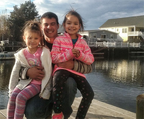 Proud father Devon Collins with his two daughters, ages 8 and 9.