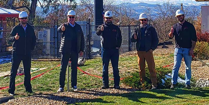 Five thumbs up from Dish's development team after a successful test of their first cell site