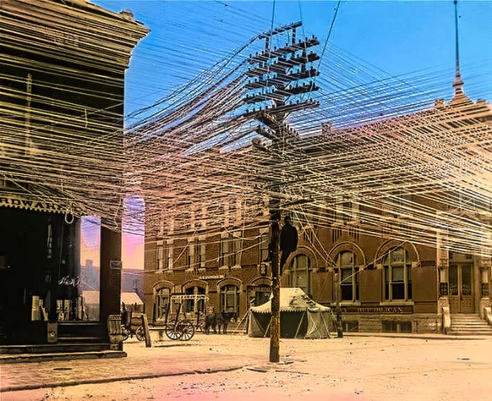 A COMMUNICATION WORKER SAFETY ZONE didn’t exist between telecom and power lines in 1911 as shown in this photo taken in Pratt, Kansas. There is one required today on poles, but Duke Energy says in its legal brief that it would not exist on its poles but for the presence of AT&T and other communications attachments. 
