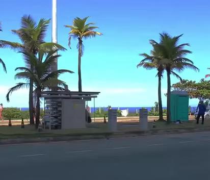 Low-profile street-level telecommunications shelter